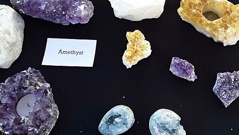 image of three different colored crystals or minerals on a black background